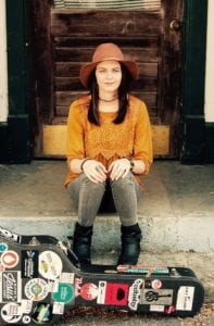 amy goloby sitting on steps with yellow shirt